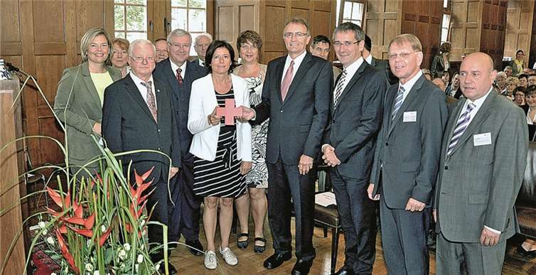 Im Kreis zahlreicher Gäste halten Ministerpräsidentin Malu Dreyer und Landrat Rainer Kaul das Rote Kreuz.uko