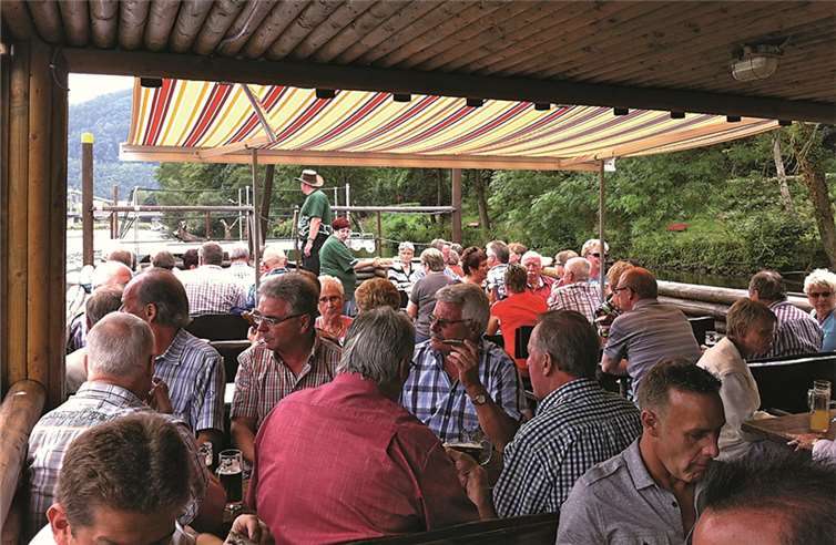 Im Vordergrund ein Teil der Floßfahrtgesellschaft auf der Lahn.