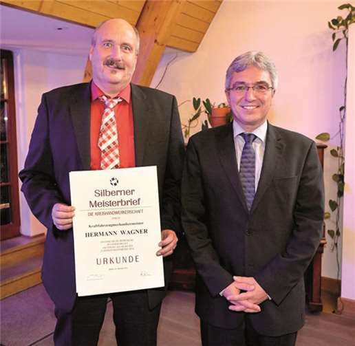 Innenminister Roger Lewentz (r.) überreichte dem Geschäftsführer und Inhaber der Autohaus Helmut Wagner GmbH, Hermann Wagner, den silbernen Meisterbrief für das Kraftfahrzeug Handwerk . privat