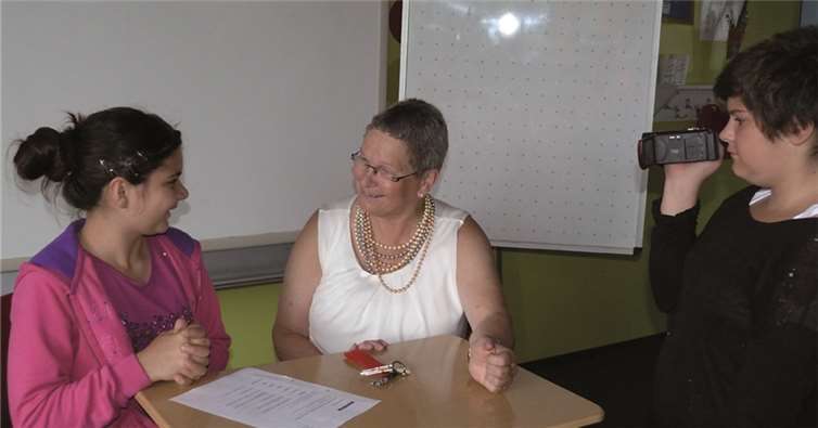 Jeanette interviewt Schulleiterin Renate Schneider. Beide werden fachmännisch von Jessica mit der Kamera aufgenommen. Privat