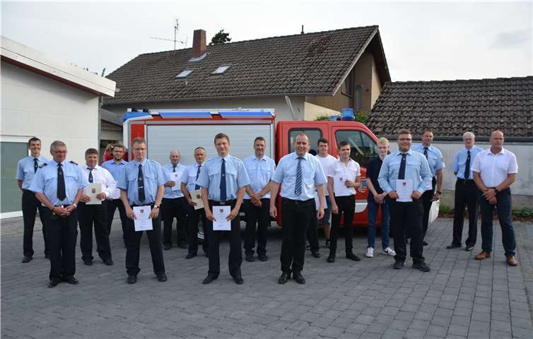 Johannes Bell (Mitte), Frank Klapperich (rechts außen) und der neue Wehrführer Christian Krupp (5. Von links) im Kreise ihrer Kameraden.Fotos: BE