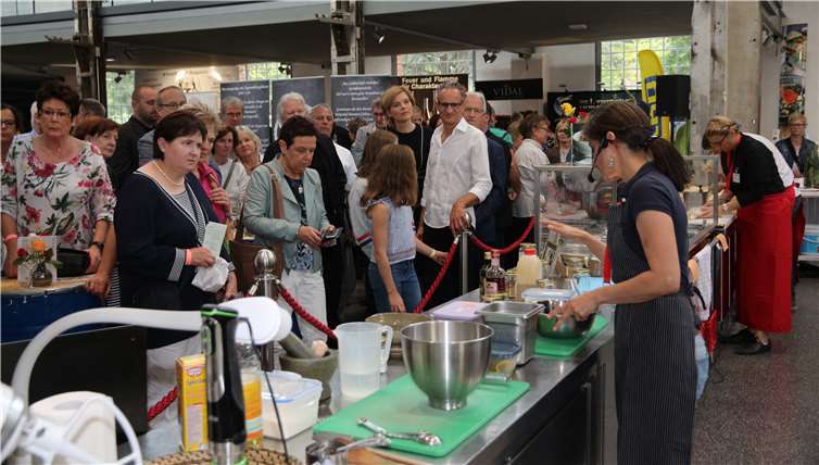 Julia Klöckner, Ralph Grieser und Josef Dötschsind interessierte Zuschauer beim Show-Cooking.