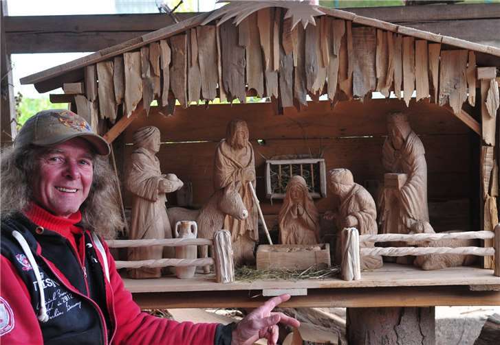 Künstler Jens Röser mit der neuen Krippe, zu dem Zeitpunktnoch in der Natur-Holz-Optik, mit der die Krippe auch schon sehr beeindruckend wirkte.Fotos: privat