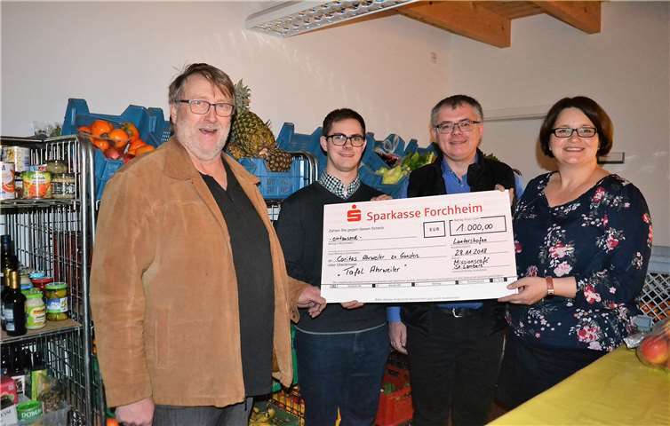 Kuno Herchenbach (links) und Christiane Böttcher (rechts) danken (Mitte) den beiden Seminaristen Andreas Heupel und Stefan Lunz für die Spende vom Studienhaus St. Lambert. E. T. Müller/Caritas