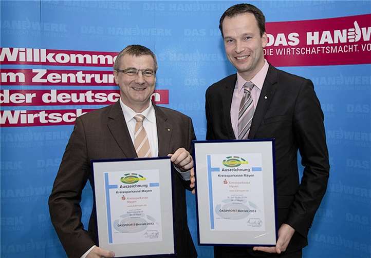 Landrat Dr. Alexander Saftig freute sich sichtlich, als er die Auszeichnung zum ÖKOPROFIT - Betrieb an das stellvertretende Vorstandsmitglied der Kreissparkasse Mayen, Christoph Weitzel, überreichte. privat