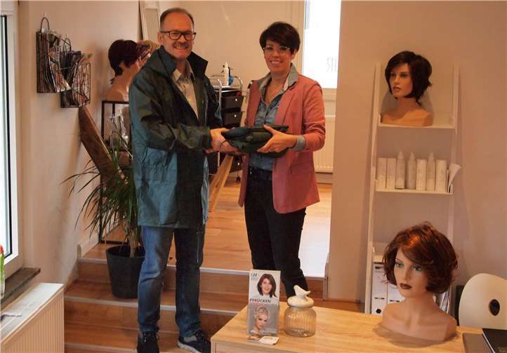 Michael Göhler vom Vorstand der Schützenkapelle Mendig nimmt die neuen Regenjacken dankend in Empfang. Foto: privat