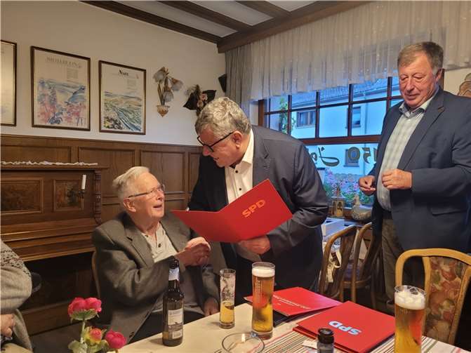 Michael Mahlert gratuliert Paul Schütz für 60 Jahre Mitgliedschaft in der SPD und Einsatz für die Interessen der Allgemeinheit. Rechts im Bild Ortsvereinsvorsitzender Horst Rasbach.  Foto: Philipp Rasbach.