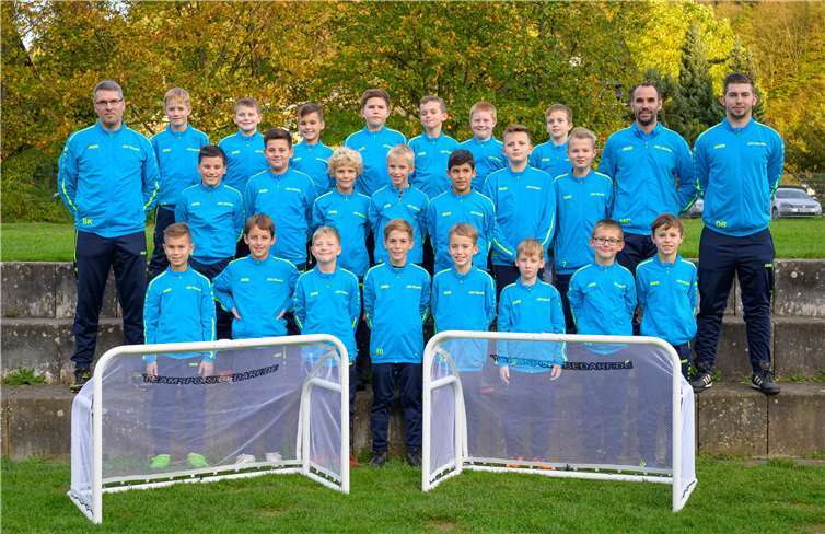 Mit Stolz präsentieren die jungen Kicker ihre neuen Trainingsanzüge und Fußballtore.Foto: Martin Baertges