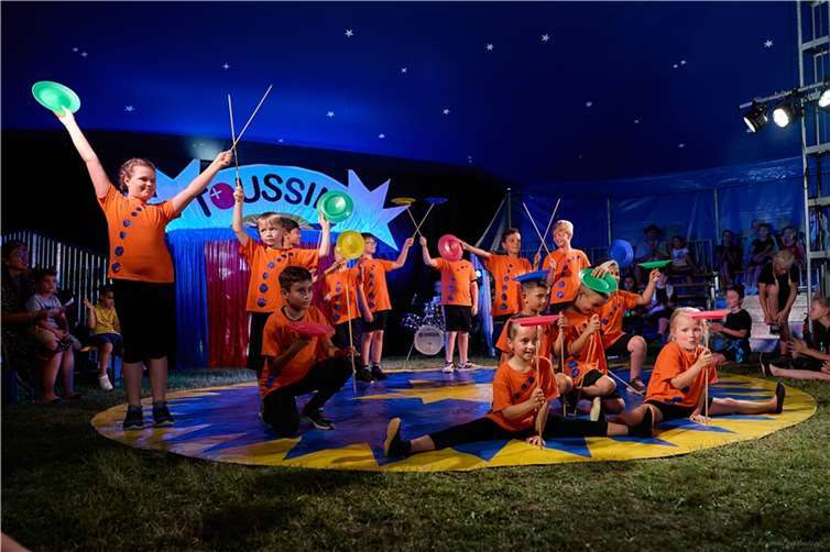 Mit voller Konzentration und Freude: Schülerinnen und Schüler der Lindenbaum-Grundschule erlernen während der Zirkusprojektwoche das Kunststück des Tellerdrehens. Foto: Christoph Wesemann