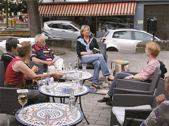 Mit welch skurrilen Erlebnissen ein Lehrerkind ironisch abrechnet, davon las Ortsvorsteherin Silvia Mühl am Brunnenplatz. RÜ