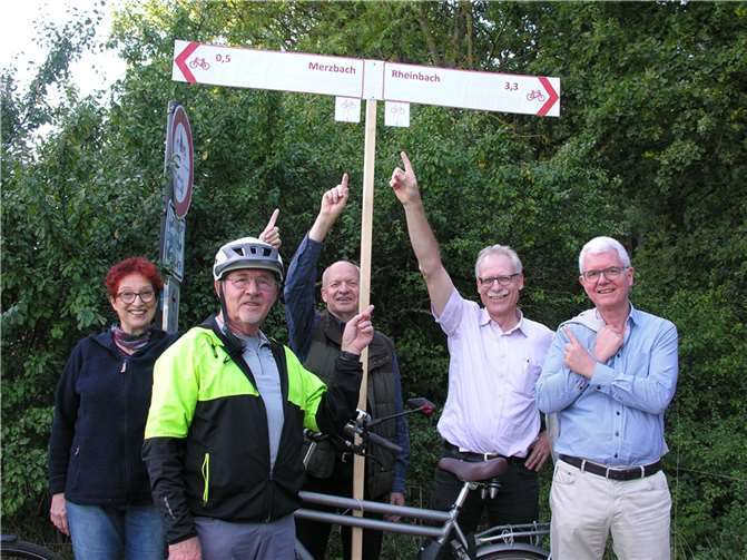 Mitglieder der Fraktionen zeigen in Merzbach, wie sie sich die Beschilderung an der Stelle, an der der Wirtschaftsweg frisch asphaltiert wurde, aussehen soll.  Foto: Georg Wilmers