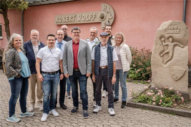 Ortsbürgermeister Florian Müller, Mitglieder des Gemeinderates, Bürgermeister Johannes Bell und Florian Herrmann von der Verbandsgemeindeverwaltung freuen sich über den Bewilligungsbescheid zur energetischen Sanierung der Robert-Wolff-Halle.  Foto: : Bernhard Risse