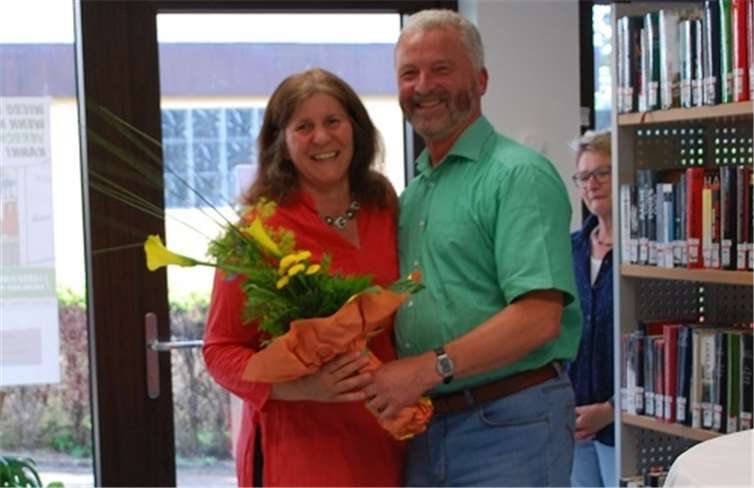 Ortsbürgermeister Uwe Schmidt dankt Birgit Karnatz mit einem Blumenstrauß und einem Geschenk.privat