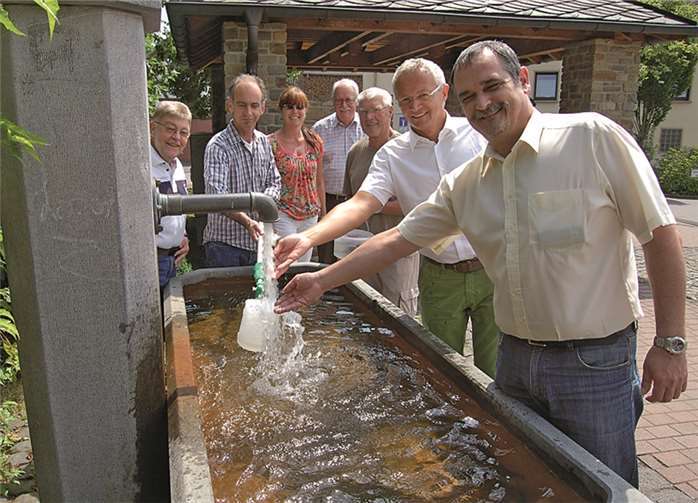 Ortsbürgermeister Volker Lemgen (vorne rechts) Vertreter der Ortsgemeinde Thalhausen und der Bürgerinitiative konnten jetzt gemeinsam mit dem 1. Kreisbeigeordneten und Umweltdezernenten Achim Hallerbach (2.v.r.) den Dorfbrunnen in der Westerwaldgemeinde wieder offiziell in Betrieb nehmen. Anfang Juli hatte die Kreisverwaltung die Zuleitung von der oberhalb liegenden Burbachquelle wieder öffnen lassen.privat
