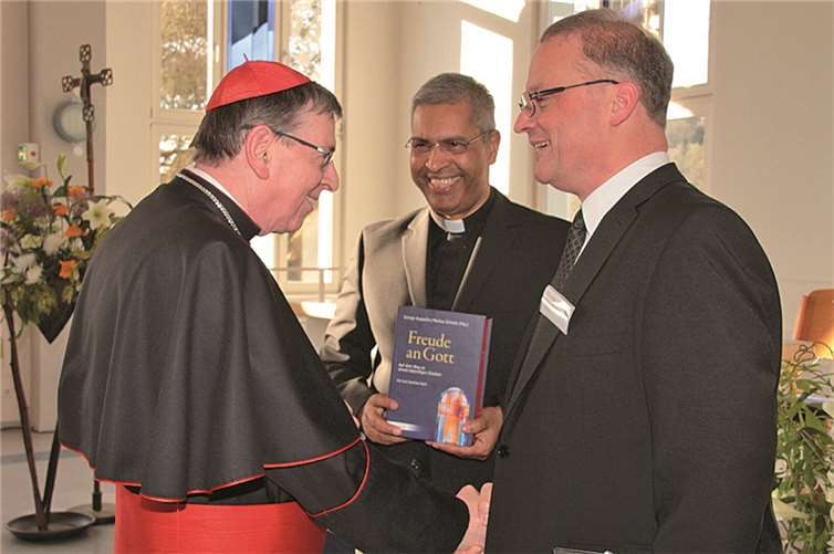 Prof. Dr. Markus Schulze (re.) überreicht Kurt Kardinal Koch die Festschrift – in der Mitte Prof. Dr. George Augustin, Leiter des Walter-Kardinal-Kasper Instituts. AND