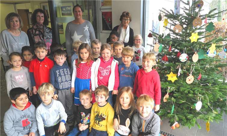 Rathaus-Weihnachtsbaum: Freuen sich über den bunt geschmückten Baum im Foyer: BMin Renate Offergeld (hinten re.), Kinder und Betreuerinnen der KinderW.E.L.T.Fotos: Gemeinde Wachtberg