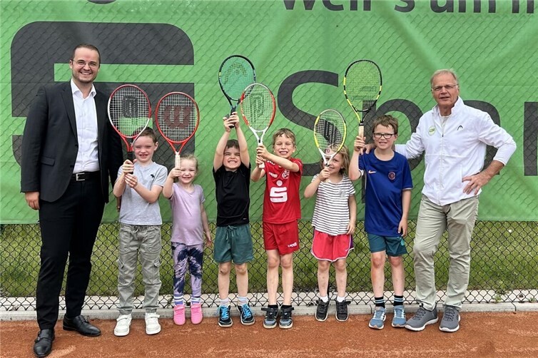 René Schell, Kreissparkasse Ahrweiler, freut sich mit den Kindern des HTC und ihrem Betreuer über die neue Ausrüstung.