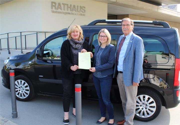 Rita Schumacher-Miltitz (Fahr- und Servicedienst Miltitz), Sarah Schwarz (Sachbearbeiterin Jugend- und Seniorentaxi), Klaus Bell (Bürgermeister) mit Nutzungsbedingungen. 