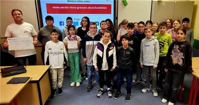 Rolf Mainz (li.), Botschafter der Organisation zusammen mir den Klassensprecherinnen und Klassensprecher der Orientierungsstufe bei der Scheckübergabe. Quelle: Realschule plus an der Römervilla