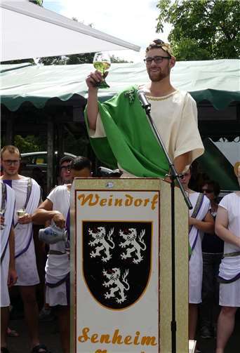 „Sehr zum Wohlsein!“ Bacchus Paul begrüßt die Senheimer Festgäste mit einem Glas leckeren Riesling.