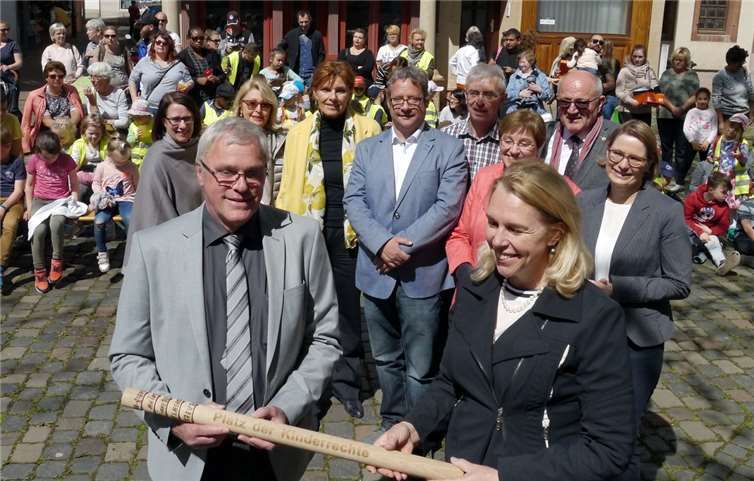 So langsam wird es schon eng auf dem Staffelholz, das Höhr-Grenzhausen zur Einweihung des ersten „Platzes der Kinderrechte“ auf die Reise geschickt hat. Stadtbürgermeister Michael Thiesen übergab es der Oberbürgermeisterin von Bad Kreuznach, Heike Kaster-Meurer. Mit dabei (zweite Reihe von rechts): Bildungsministerin Stefanie Hubig, DKSB-Präsident Heinz Hilgers und die Vorsitzende des Kreisverbandes Westerwald/Ortsverband Höhr-Grenzhausen, Heidi Ramb. Foto: privat