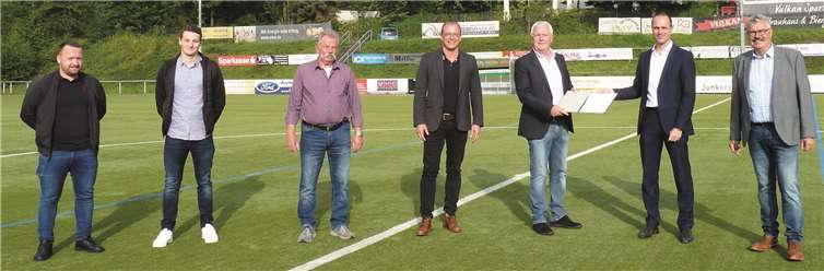 Staatsminister Clemens Hoch (2.v.rechts) überreicht dem 1. Vorsitzenden des SV Eintracht Mendig, Bernd Krayer (3.v.rechts) den Förderbescheid.Foto: FRE