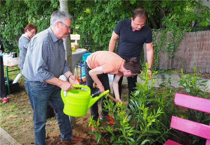 Stadtbürgermeister Ammel und Bürgermeister Lempertz packten seinerzeit bei der Aufstellung der Bank und der Bepflanzung des Areals beide mit an, damit ein Ort der Begegnung entstehen konnte.