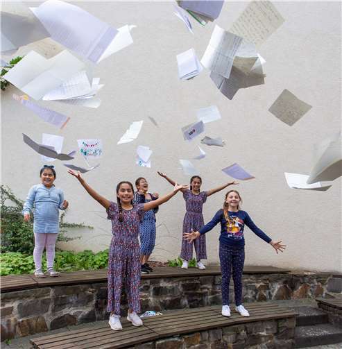 Stapelweise erreichten liebevoll gestaltete Leseberichte die Bücherei. Die fröhlichen Gewinnerinnen des Lesesommers werfen sie in die Luft: v.l. Asmin, Ceylin, Defne, Helin und Jolina Marie. Foto: privat