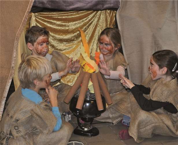 Steinzeitmenschen am wärmenden Steinzeitfeuer. privat