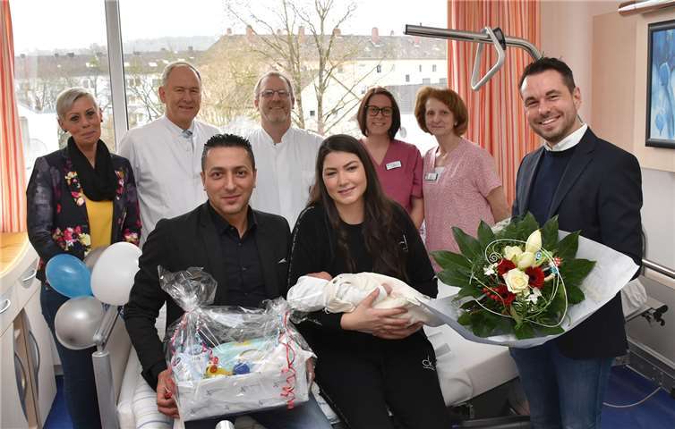 Strahlende Eltern: Cengiz und Aysegül Kiziltoprak (sitzend, mit Feyzi). Glückwünsche für das Koblenzer Neujahrsbaby überbringen Oberbürgermeister David Langner (rechts) sowie Vertreter des Kemperhofs (von links): Dagmar Wagner (Klinkmanagerin), Prof. Dr. Bernd Markus (Ärztlicher Direktor), Dr. Sebastian Friederichs (Leitender Oberarzt), Katrin Steffens (Hebamme) und Karin Lauer (stellv. Stationsleiterin).Quelle: Gemeinschaftsklinikum Mittelrhein