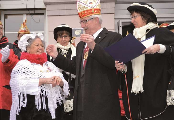 Unerschrocken holten die Möhne ihre Maria Schorn (li.), die erkrankt war, kurzerhand aus dem Bett, und vor dem Rathaus wurde sie von Willi Fuhrmann, im Beisein der Obermöhn Ingrid Efferzfür für ihre enormen Dienste ausgezeichnet. AB
