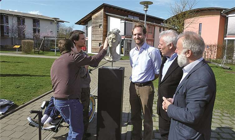 Unmittelbar nach der Enthüllung durch Dr. Alfred Marmann, Wolfgang Krause und Christian Felder (v.r.) beschäftigten sich Bewohner der FWS mit der Büste. privat