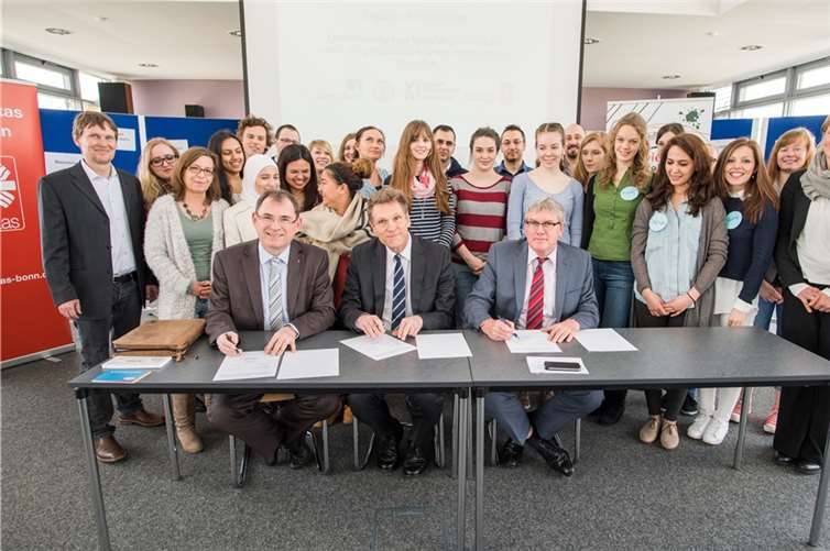 Vertragsunterzeichnung, sitzend v.li.: Caritas-Direktor Jean-Pierre Schneider, Dekan Prof. Dr. Andreas Bartels und Landrat Sebastian Schuster.Volker Lannert/Uni Bonn
