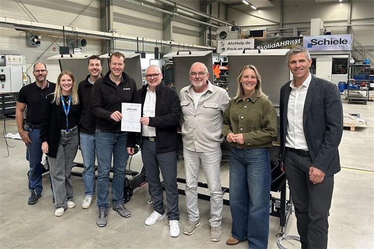 Vertreter der Schiele Maschinenbau GmbH, der Realschule plus Niederzissen und der beteiligten Partner erneuern die Schulpatenschaft und präsentieren gemeinsam die Urkunde in der Firmenhalle von Schiele. Die Partnerschaft soll die Berufsorientierung stärken und jungen Menschen berufliche Perspektiven in der Region eröffnen.