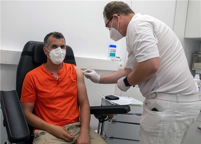 Vor dem eigentlichen Piks desinfiziert Dr. Jörg Quernheim die Einstichstelle am Oberarm von Krimo Sais.Fotos: JOST