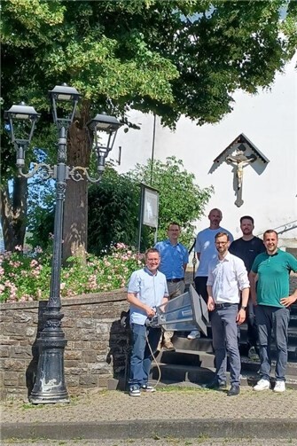 Vor der Kirche in Oberelbert trafen sich zur „letzten Laterne“ (vorne v.l.) Ortsbürgermeister Sebastian Stendebach, VG-Bürgermeister Ulrich Richter-Hopprich, Betjus Berisa und (hinter ihm) Matthias Rubin von Siteco sowie die beiden Projektleiter der VG Rafael Platzek (hinten Mitte) und Kay Bröhl.