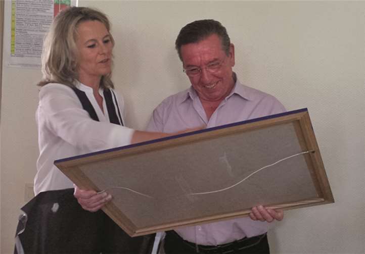 Vorsitzende Sabine Hecker überreicht dem scheidenden Ortsbürgermeister Konrad Löhndorf aus Dankbarkeit für seine langjährige Tätigkeit ein Bild von der Kalenborner Kapelle. privat