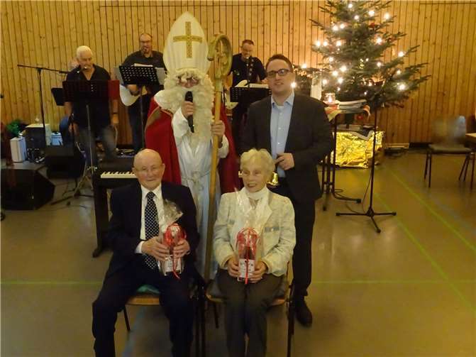 Walburga Barz und Alois Harst erhielten als älteste Teilnehmer der Seniorenfeier vom Nikolaus ein Präsent. Fotos: WER