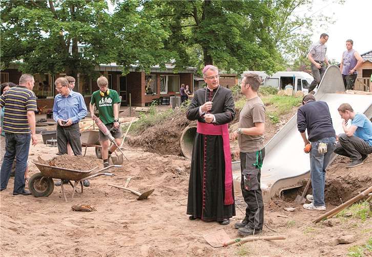 Weihbischof Peters (Mitte) informiert sich über das Projekt und lobt das Engagement der jungen Leute. privat
