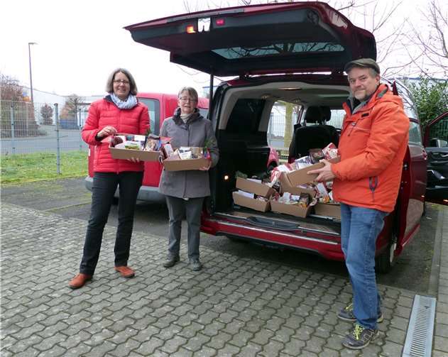 Weltladensprecherin Silke Olesen (l.) übergibt die Präsentkisten an Gabriele Merten und Christoph Schomer. Foto: privat