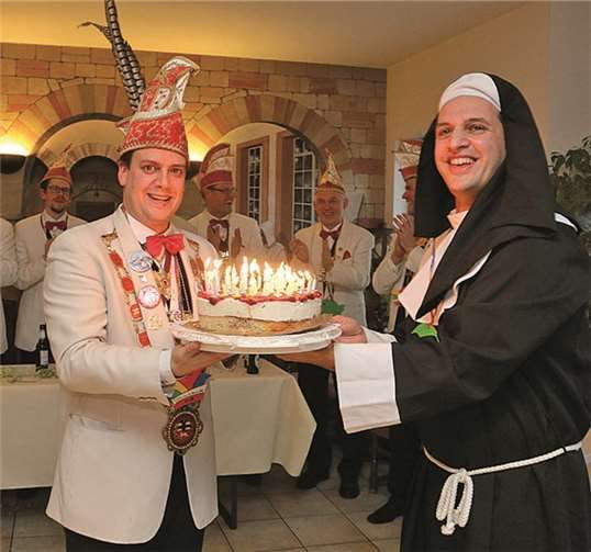 Zum Jubiläum der KG überreichte Raphael Sorbilli an Sitzungspräsident Thomas Sebastian eine Torte mit 55 Kerzen.