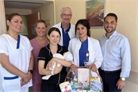 Team und glückliche Eltern freuen sich über die 1001. Geburt